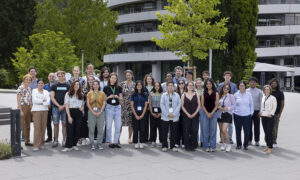Group photo showing about 30 people outside the EMBL ATC building.
