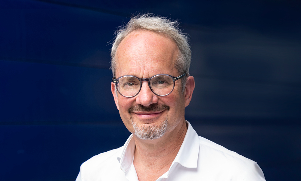 Male scientist with glasses in a white shirt