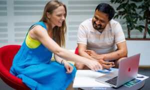 Two colleagues sitting together in front of a computer