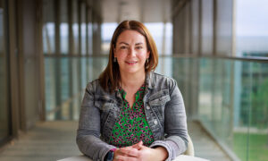 Photograph of a woman sitting at a table