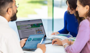 people around a laptop computer