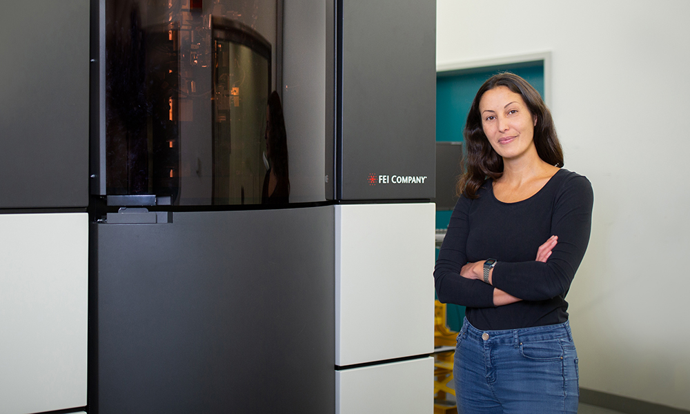 Scientist standing next to a cryo-ET machine