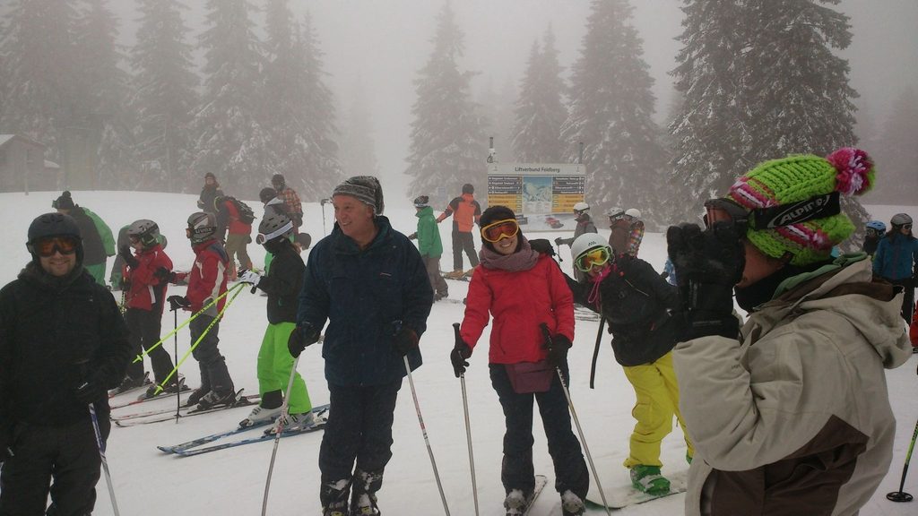 several people skiing on a grey day